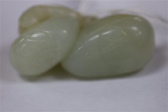 A Chinese pale celadon jade carving of two ducks biting lotus, 19th century L. 5.3cm